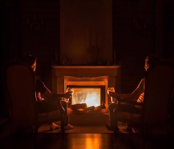 2 people at a fireplace