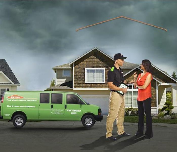 SERVPRO technician consulting with customer