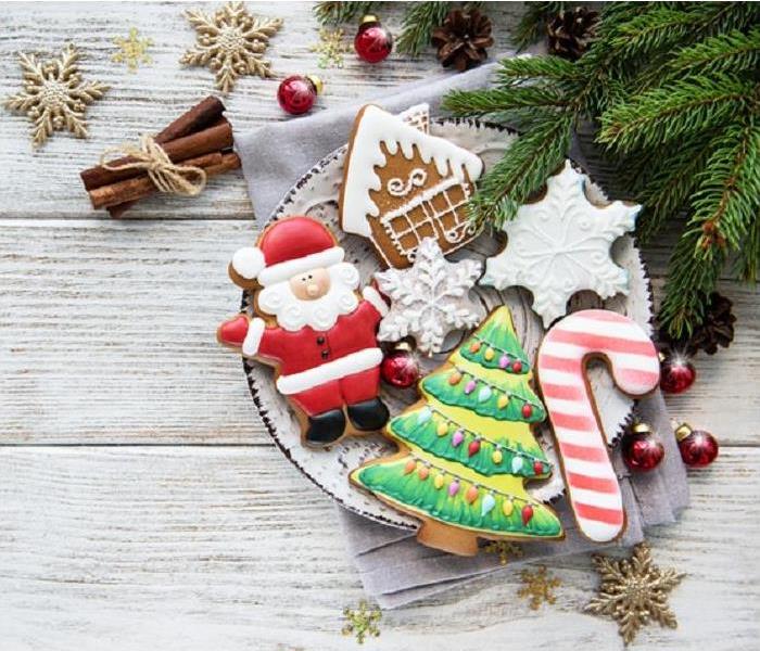 platter of Christmas cookies; greenry beside plate