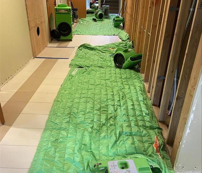 GREEN QUILTED DRYING MATS IN CORRIDOR